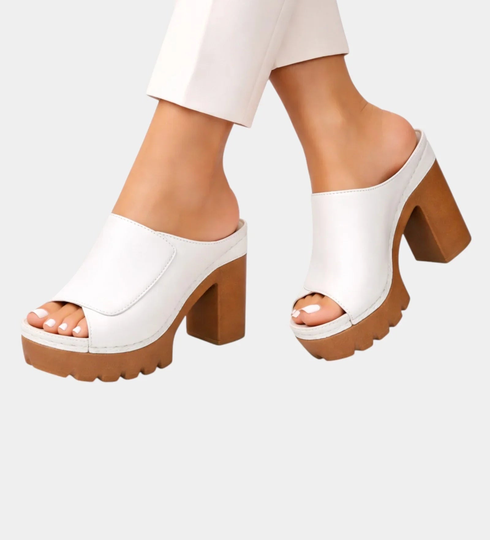 White platform heeled mules with open toe, slip-on upper and chunky lug sole