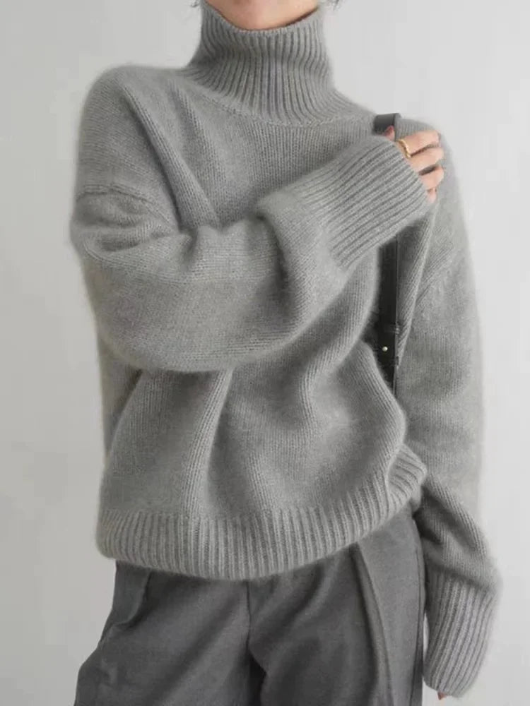 Gray cashmere knit turtleneck sweater with ribbed collar, cuffs, and hem, long sleeves.