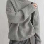 Gray cashmere knit turtleneck sweater with ribbed collar, cuffs, and hem, long sleeves.