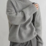 Gray cashmere knit turtleneck sweater with ribbed collar, cuffs, and hem, long sleeves.