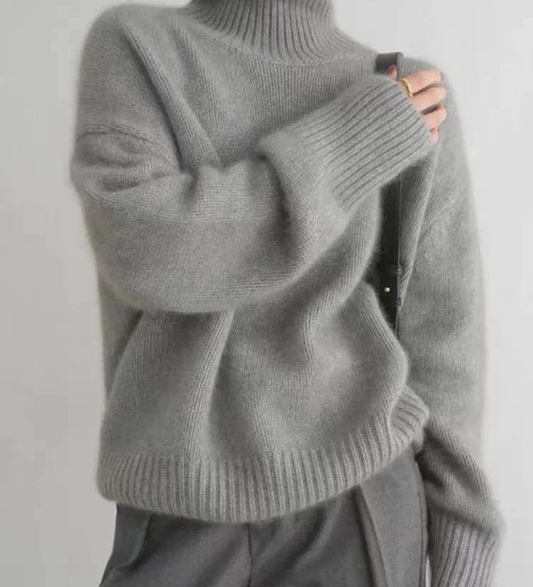 Gray cashmere knit turtleneck sweater with ribbed collar, cuffs, and hem, long sleeves.