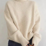 Beige ribbed turtleneck cashmere sweater with dropped shoulders and long sleeves.