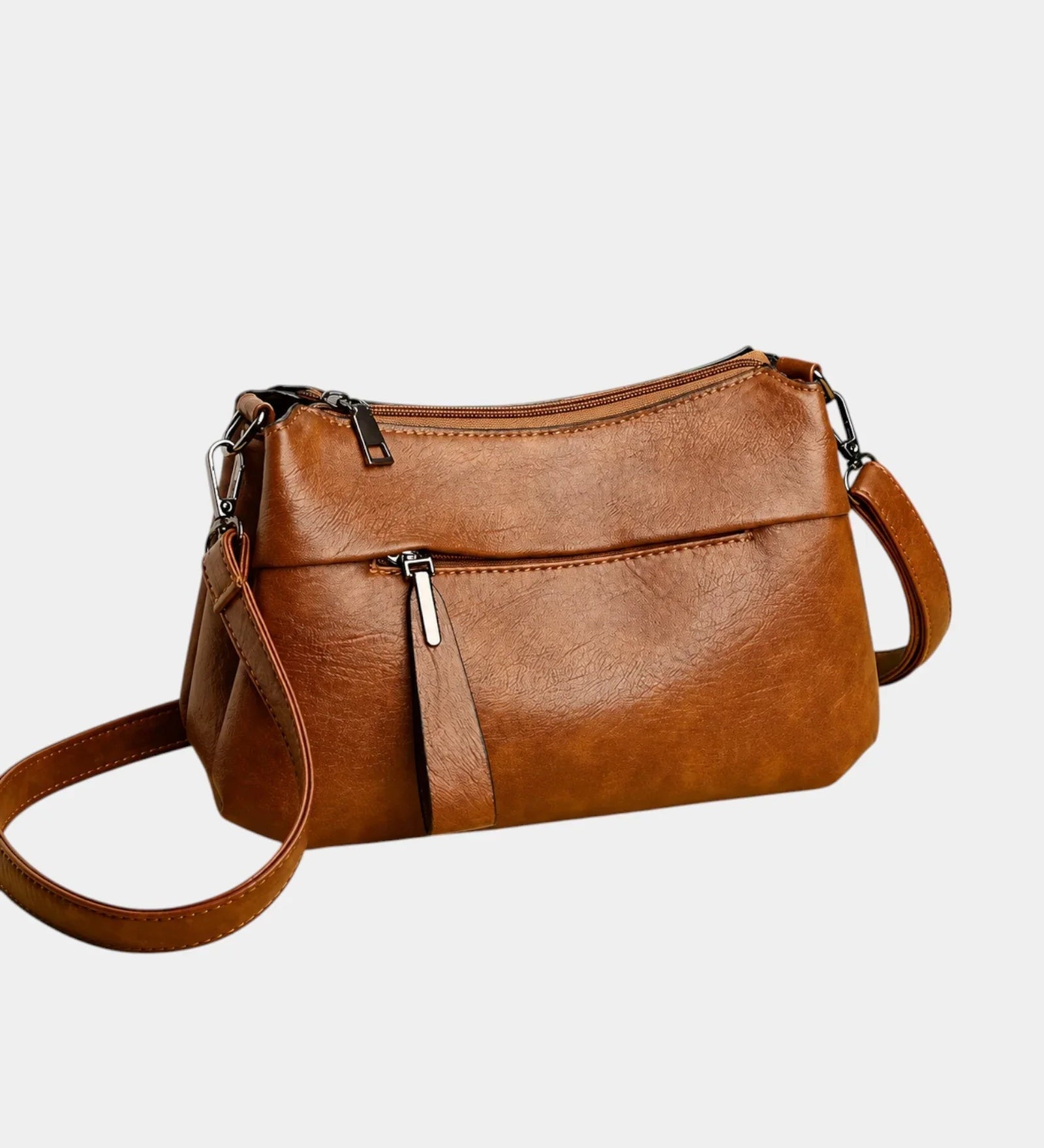 Brown leather shoulder bag with zip-top and adjustable crossbody strap