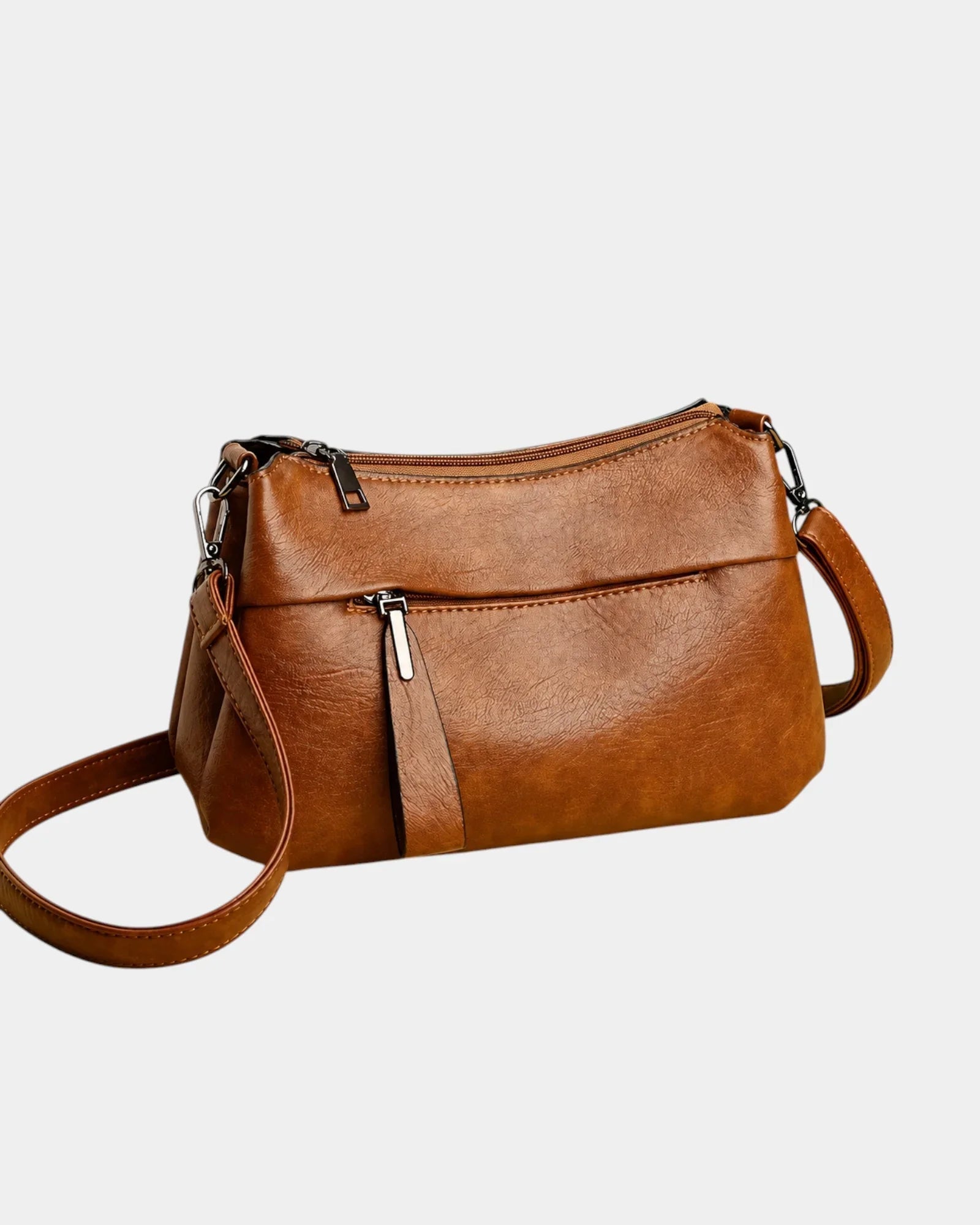 Brown leather shoulder bag with zip-top and adjustable crossbody strap