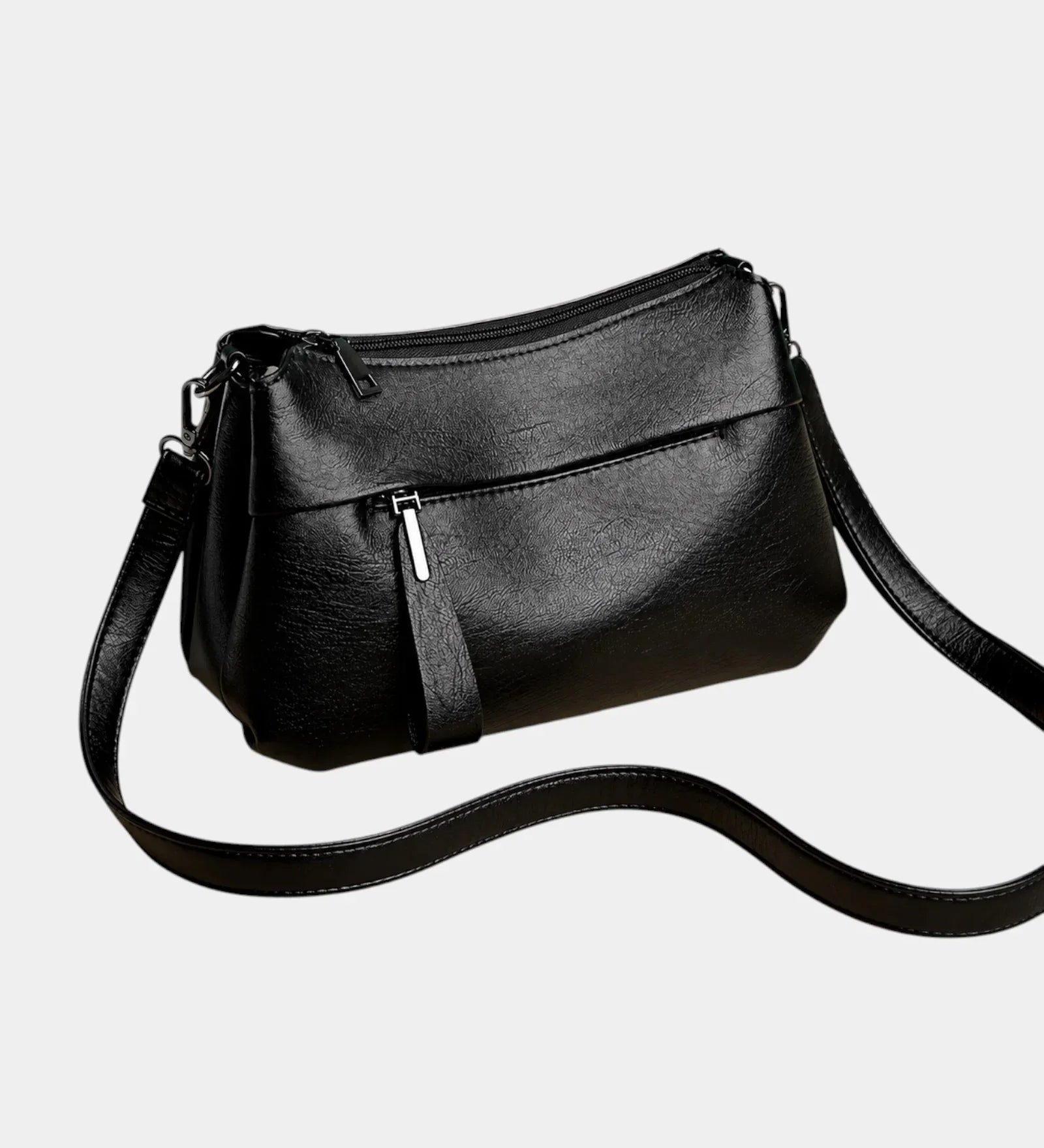 Black leather shoulder bag with zip-top, front pocket, and crossbody strap