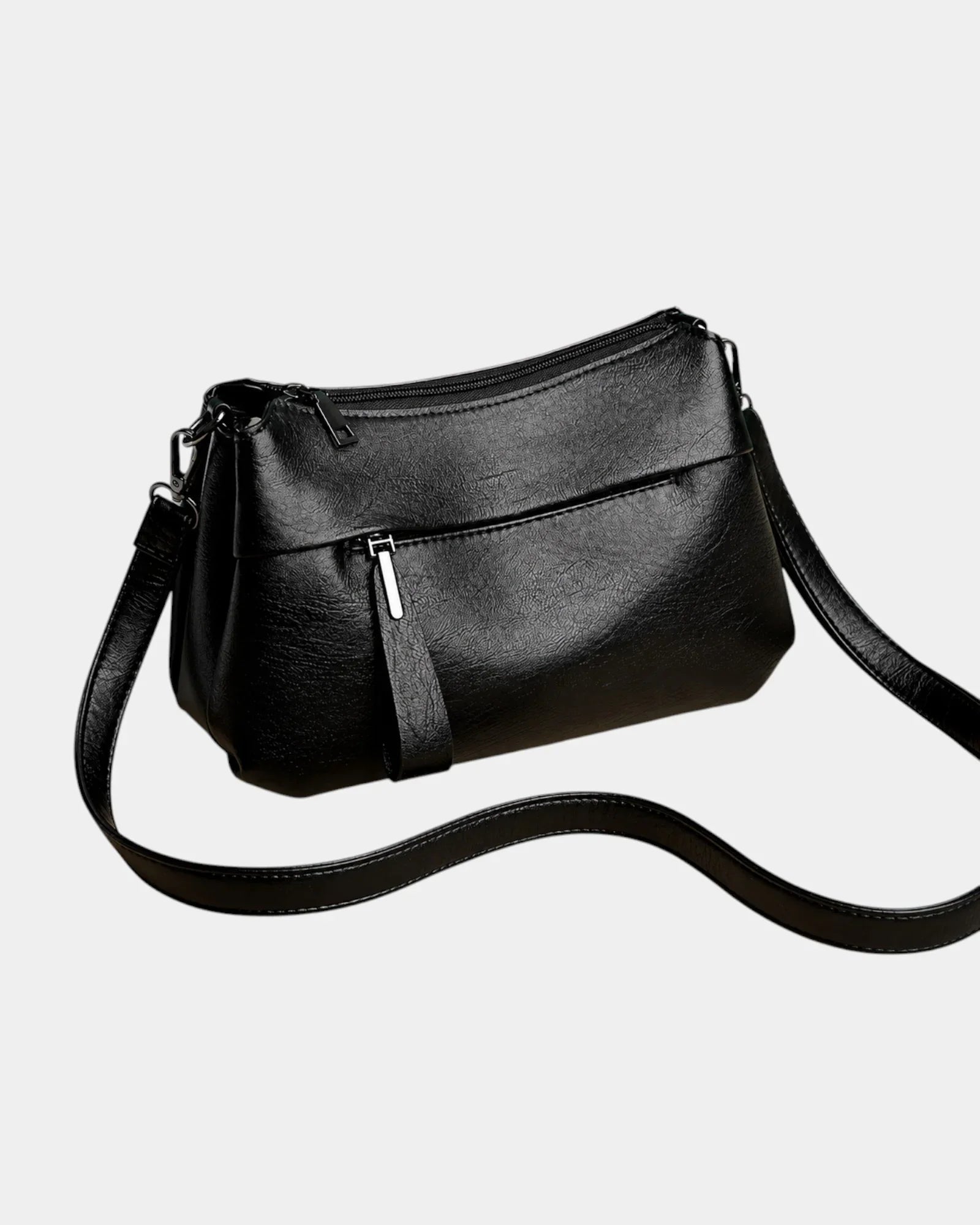 Black leather shoulder bag with zip-top, front pocket, and crossbody strap