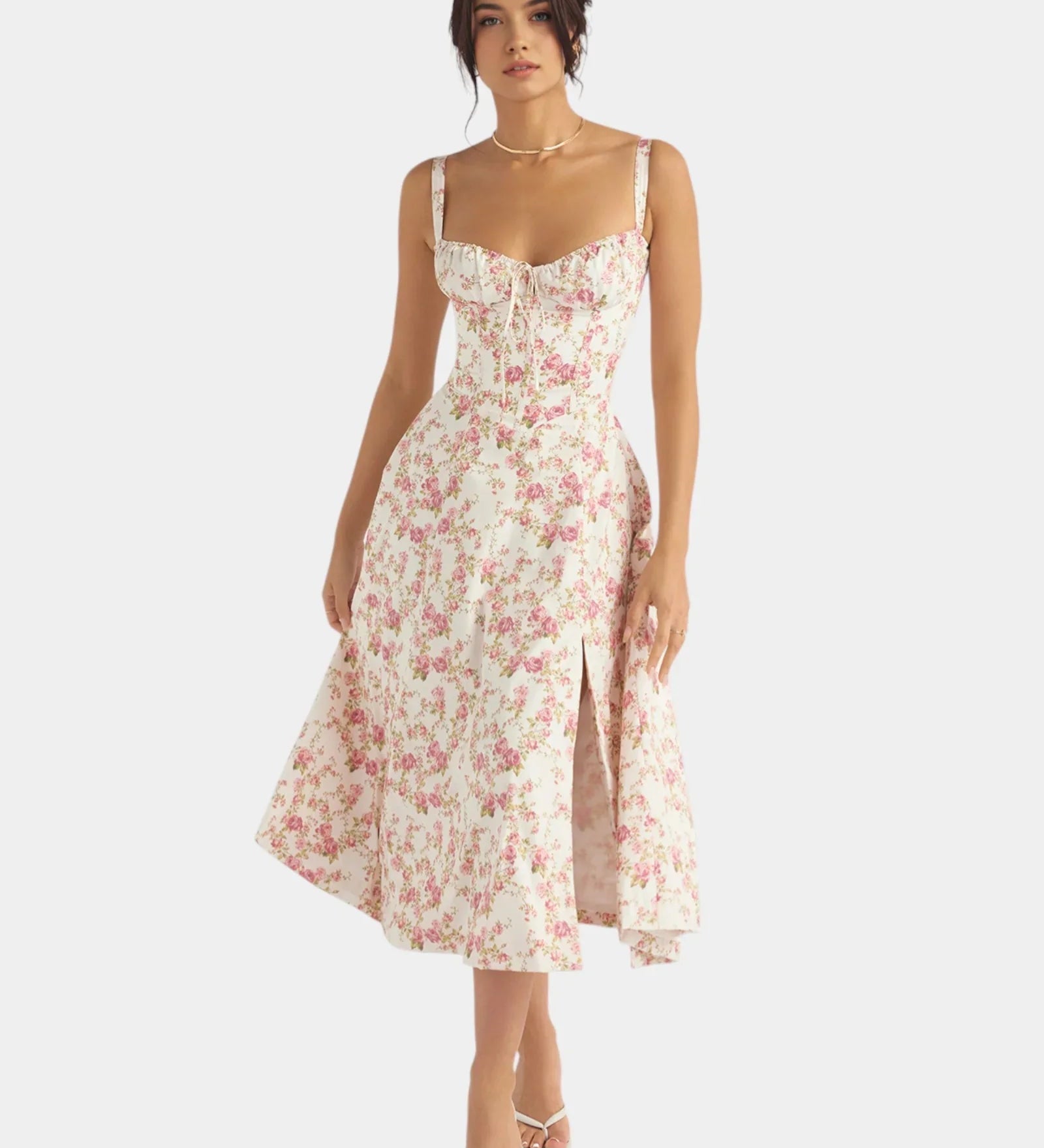 Floral pink midi dress with spaghetti straps, fitted bodice, and flared skirt