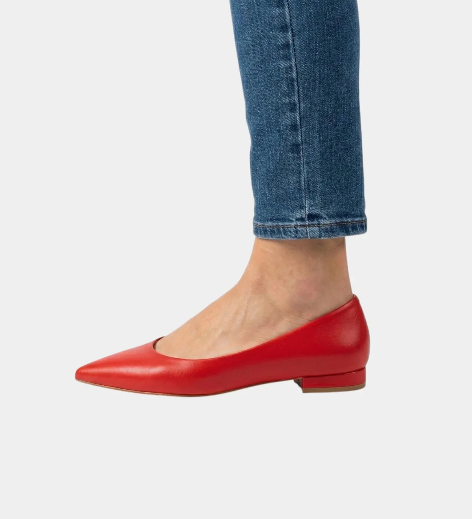 Red pointed-toe low-heel flats with a sleek slip-on design and minimal seams.