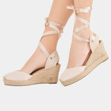 Beige high-heel espadrille wedge sandals with lace-up ankle straps