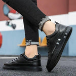 Black lace-up orthopedic shoes with side stripe worn with dark pants