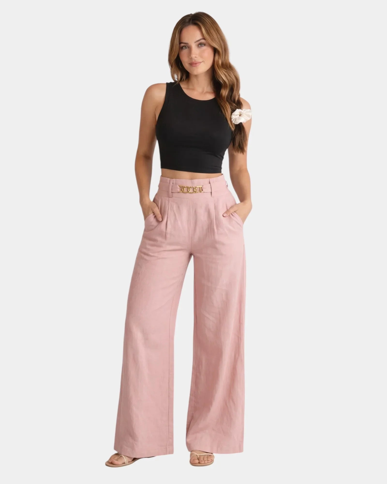 Pink high-waist wide-leg pants with gold chain belt detail