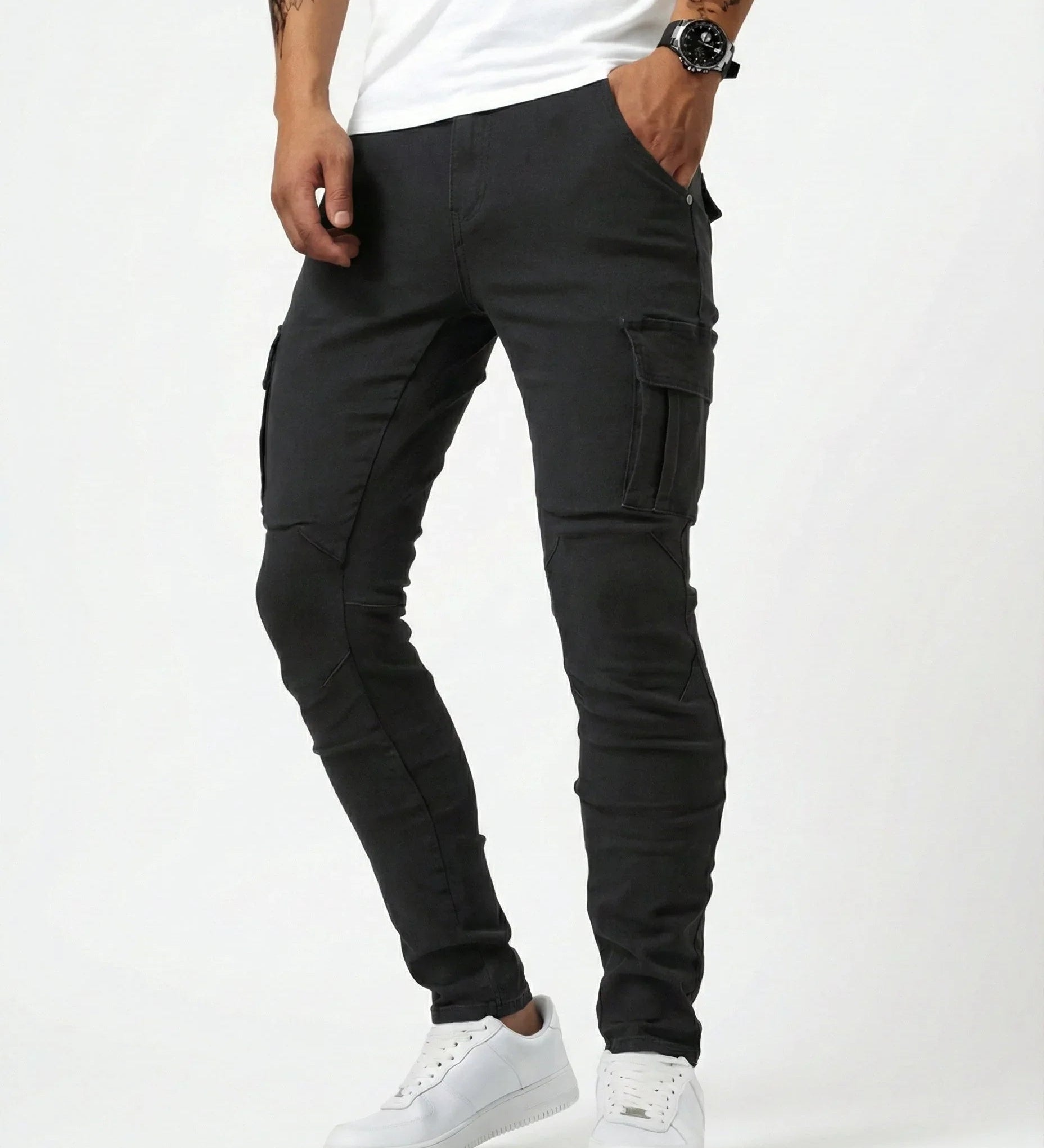 Black elastic cargo pants with thigh cargo pockets and flap detail, tapered legs