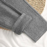 Gray herringbone trousers with cuffed hem and button placket