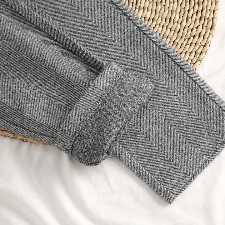 Gray herringbone trousers with cuffed hem and button placket