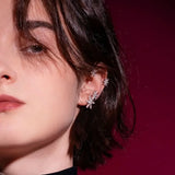 Silver star ear cuff with glittering cross stars on outer ear