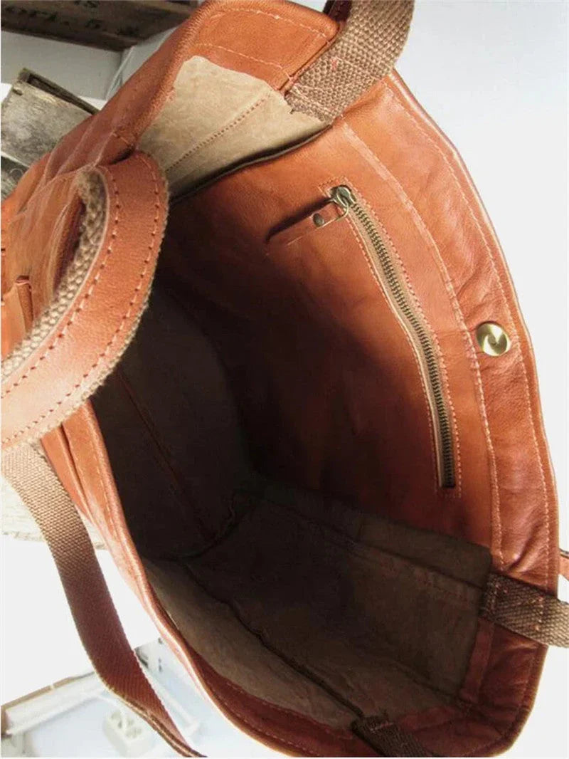 Tan leather tote bag interior view with zip pocket and shoulder strap