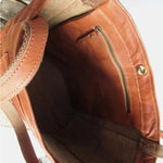 Tan leather tote bag interior view with zip pocket and shoulder strap