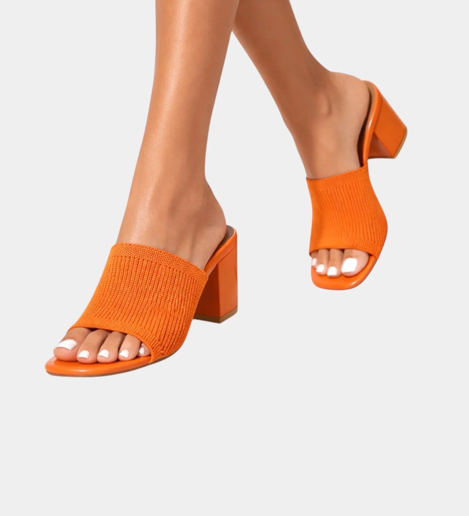 Orange block-heel sandals with ribbed knit slip-on straps and open toe.