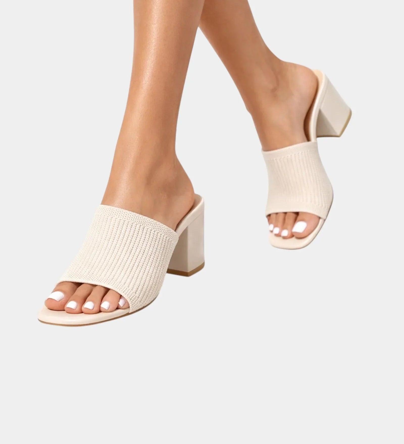 Cream block-heel sandals with ribbed knit slip-on straps and open toe.