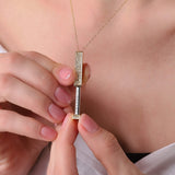 Gold-tone bar pendant necklace showing 'I love you' text between clear stones