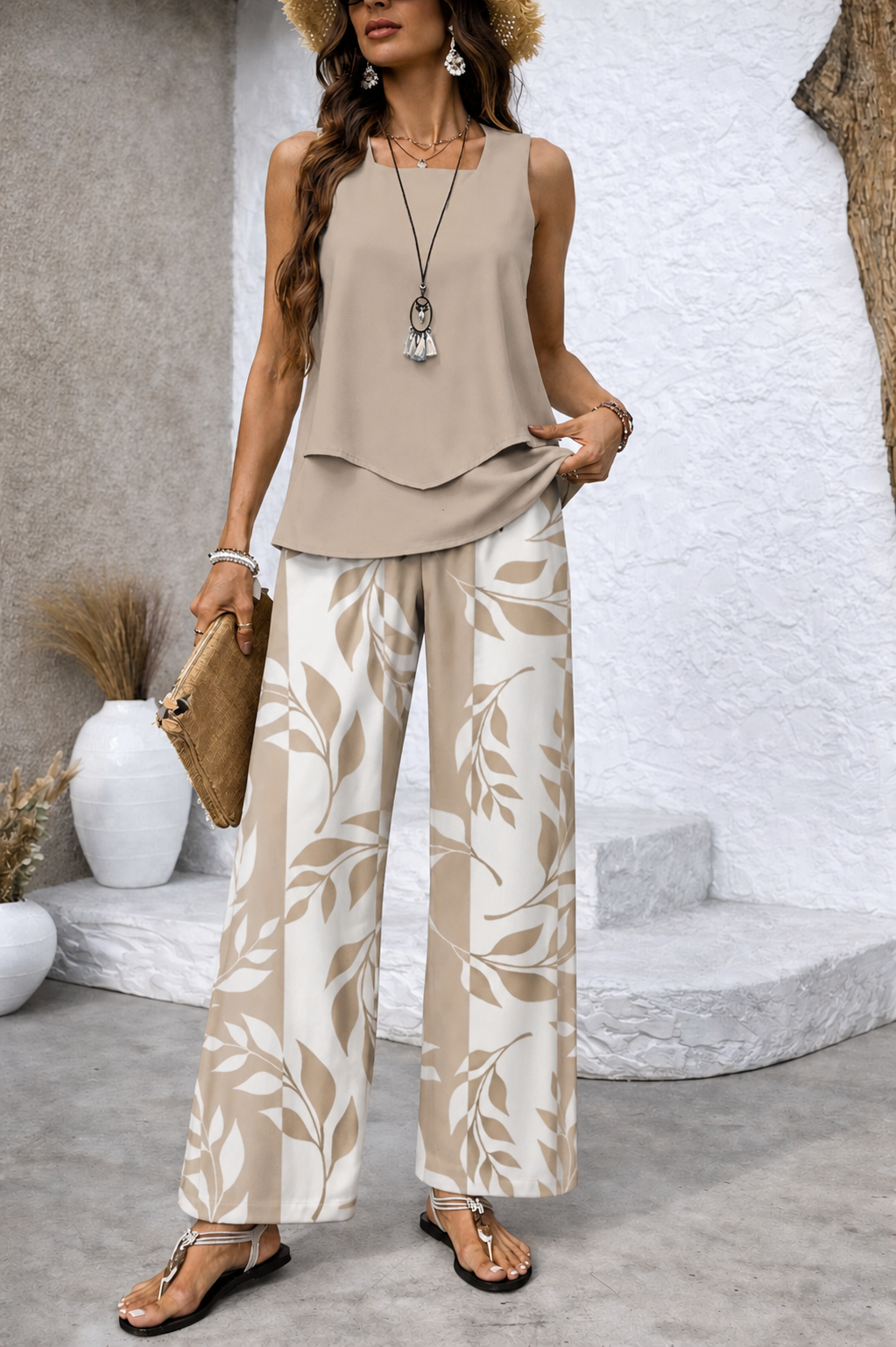 Draped beige sleeveless top with botanical wide-leg trousers