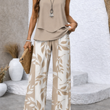 Draped beige sleeveless top with botanical wide-leg trousers