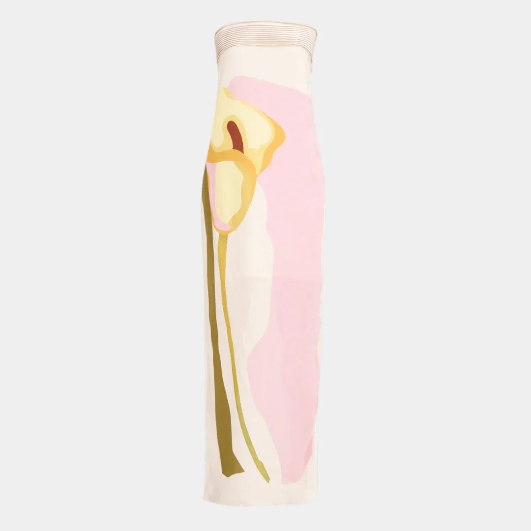 Strapless maxi dress close-up: abstract face graphic in pink and yellow on cream
