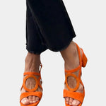 Orange square-toe sandals with rounded cutout straps and ankle buckle