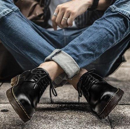 Black lace-up casual shoes with chunky tan sole and contrast yellow stitching