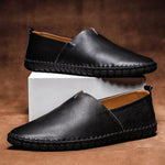 Black leather slip-on espadrilles set with jute midsole and orange stitched edge