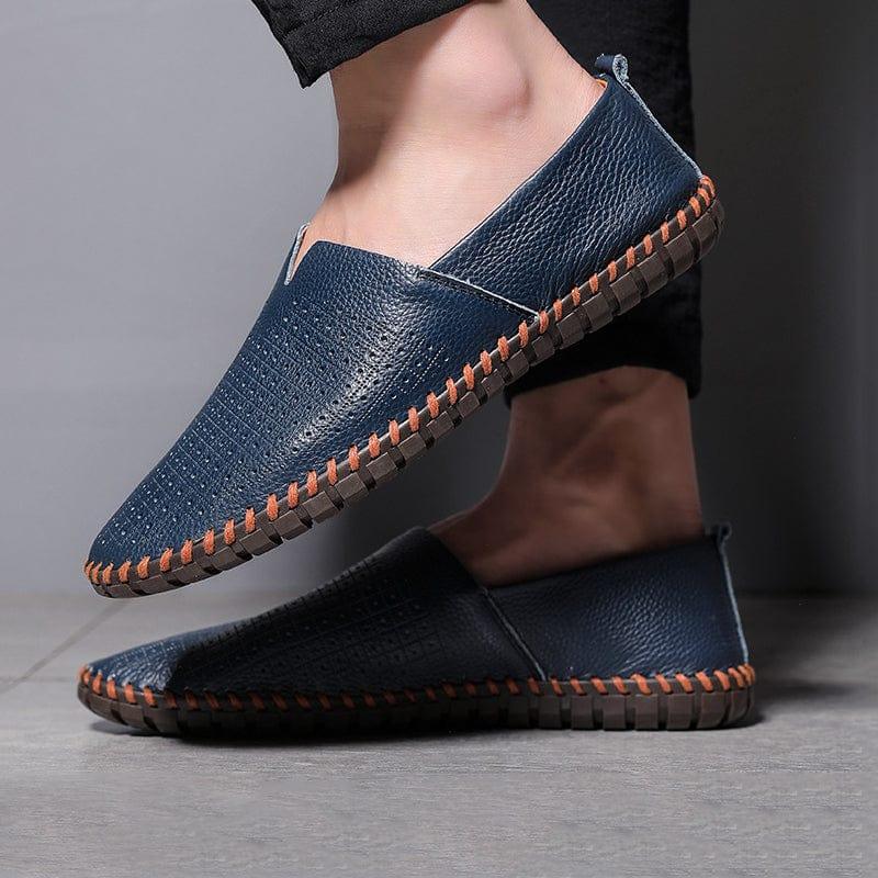 Blue and black leather slip-on espadrilles with orange stitched trim on feet