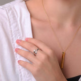 Silver-to-gold layered look ring with wave edges on finger