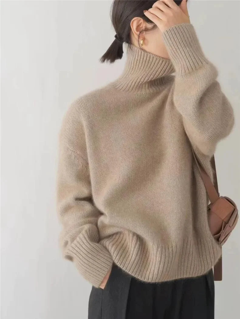 Beige turtleneck knit sweater with ribbed cuffs and hem, long sleeves, relaxed fit.