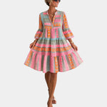 Printed midi dress with V-neck, tiered skirt, and bell sleeves in pink, orange, and greenish