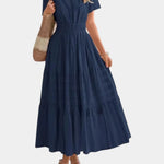 Navy tiered maxi dress with V-neck, short sleeves, and gathered waist seams