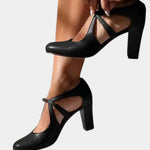 Black heeled slingback pumps with thin ankle tie straps and pointed toe