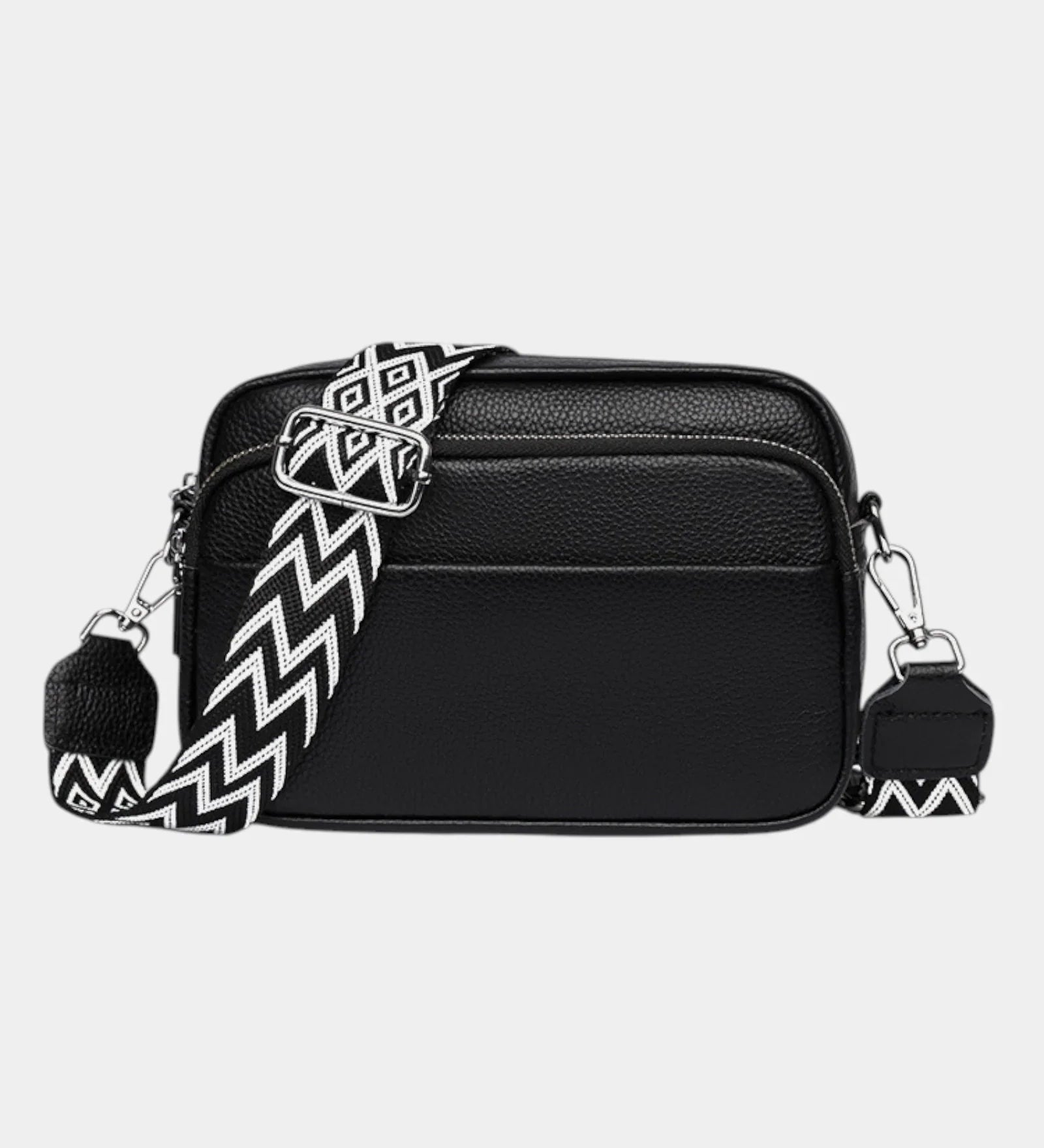 Black leather-look crossbody bag with silver hardware and zigzag patterned strap