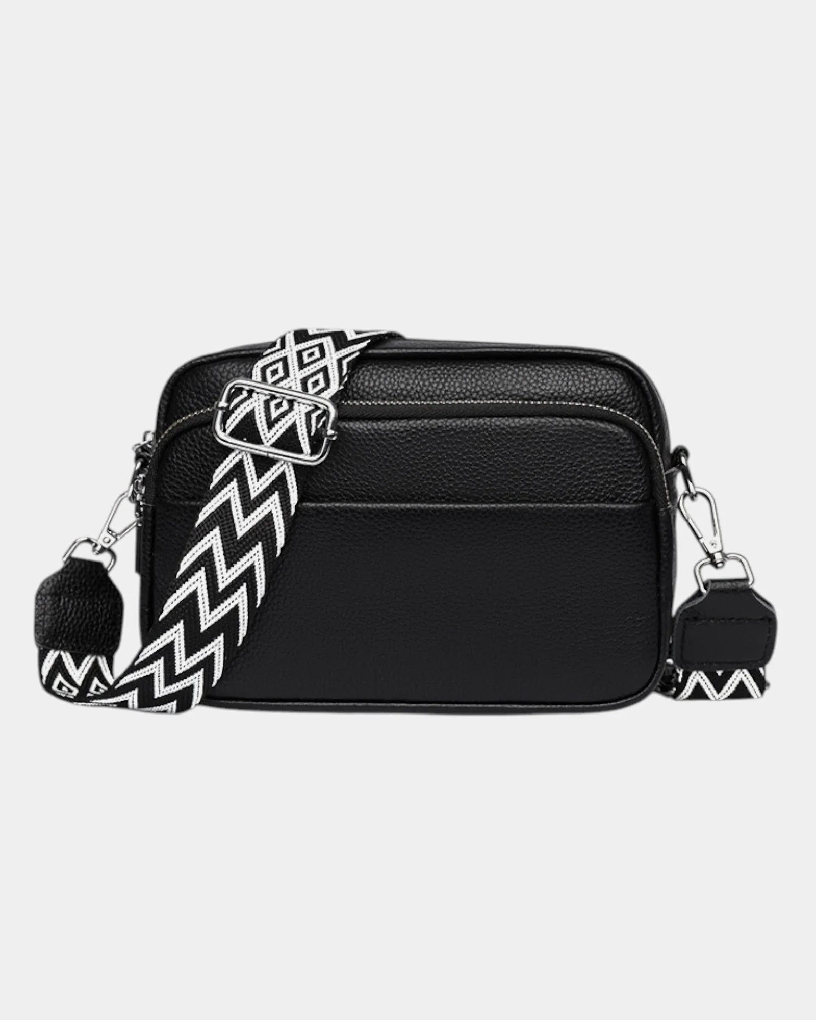 Black leather-look crossbody bag with silver hardware and zigzag patterned strap