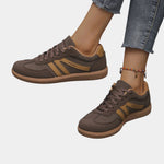 Brown orthopedic sneakers with gold side stripes and tan gum sole