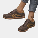 Brown orthopedic sneakers with gold side stripes and tan gum sole