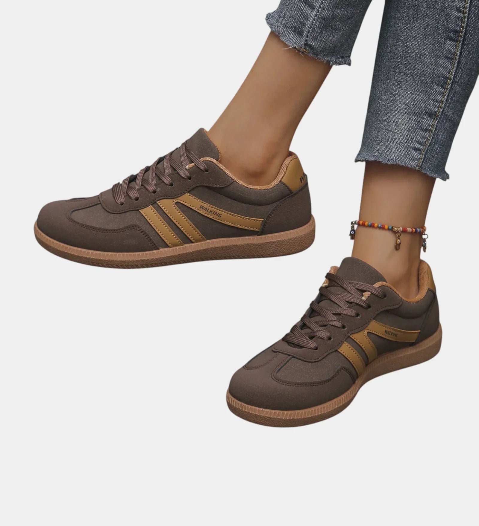 Brown orthopedic sneakers with gold side stripes and tan gum sole