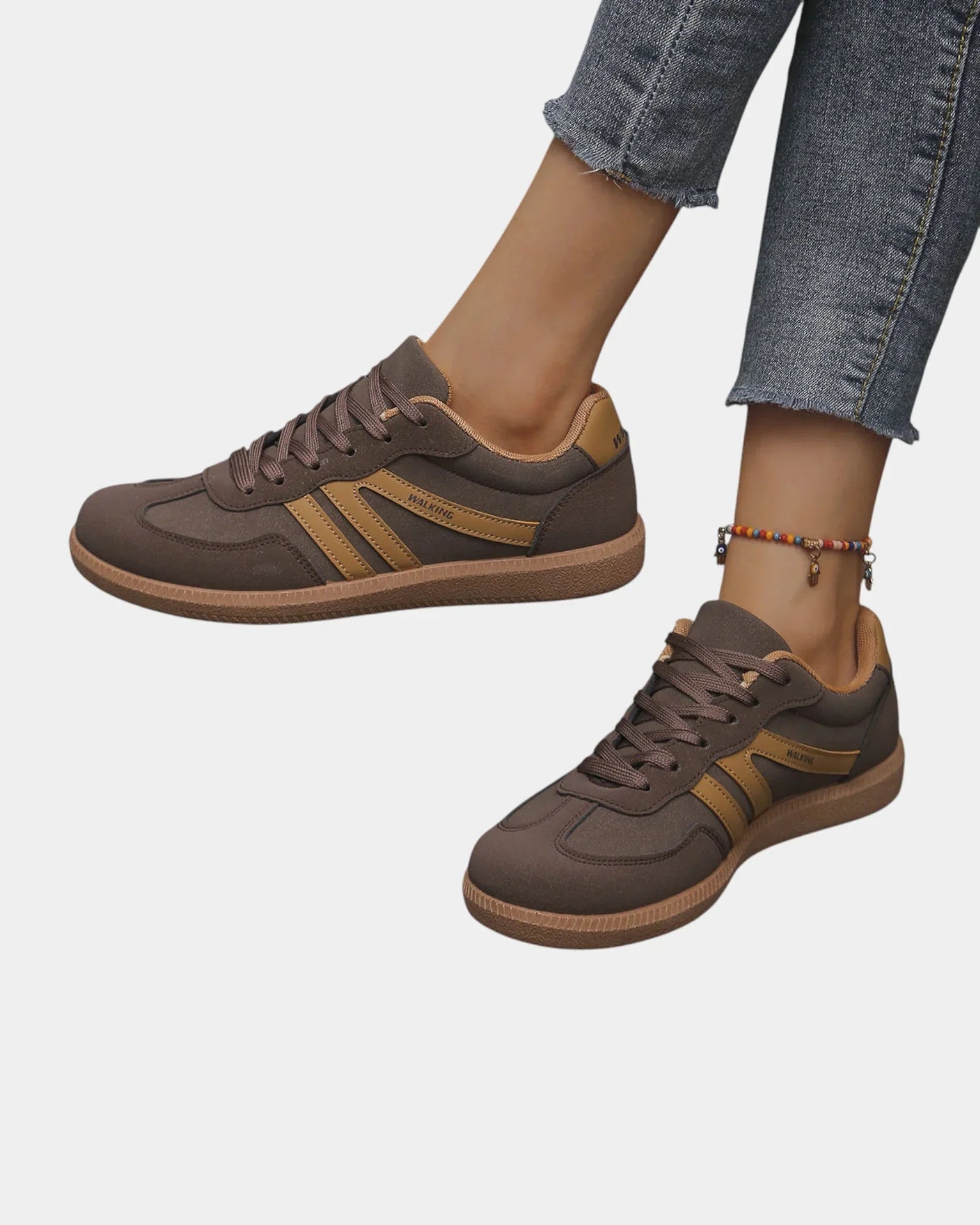 Brown orthopedic sneakers with gold side stripes and tan gum sole