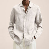White linen-look long-sleeve button-up shirt with pointed collar.