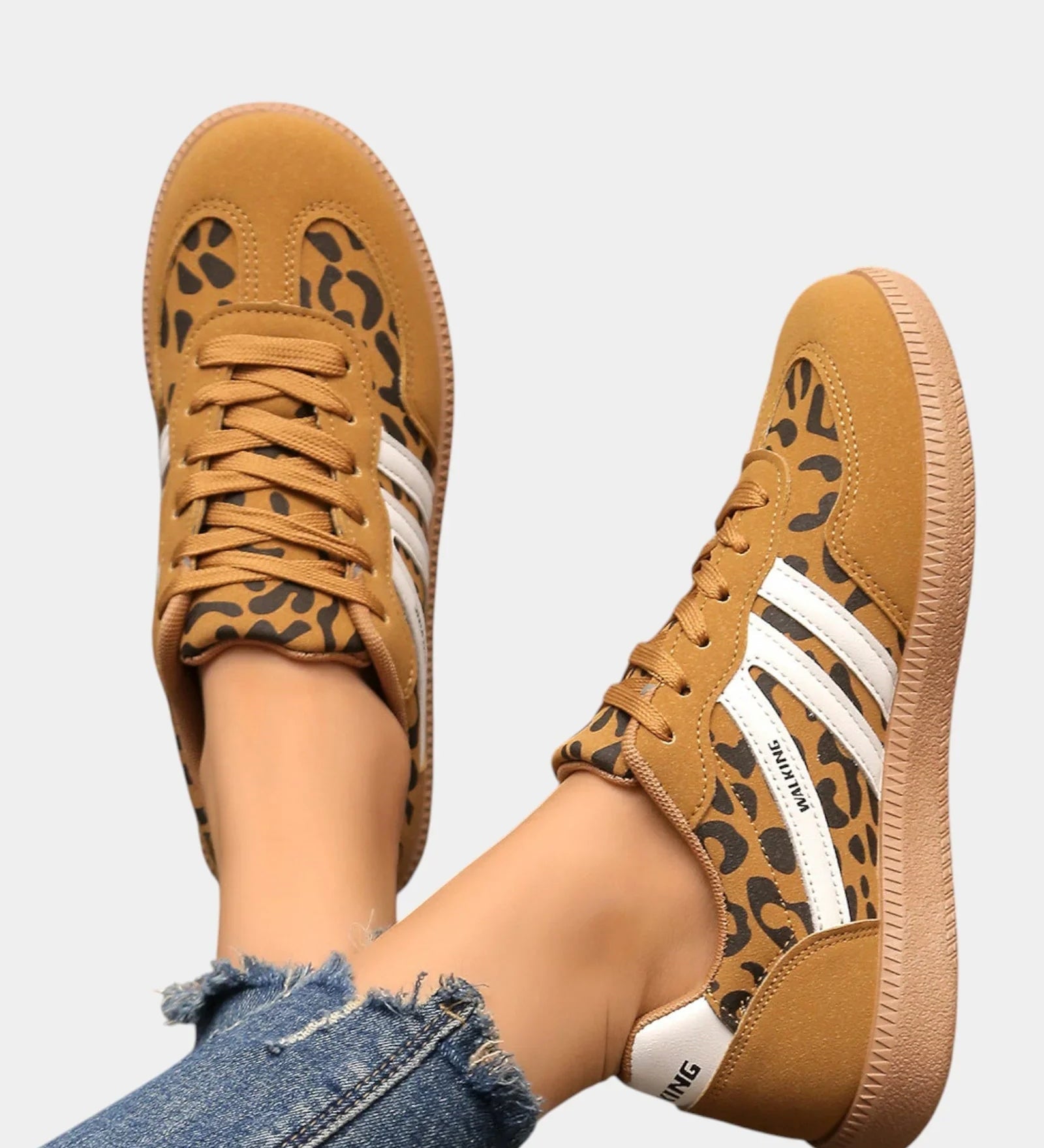 Leopard-print orthopedic sneakers with tan laces, white stripes, gum sole