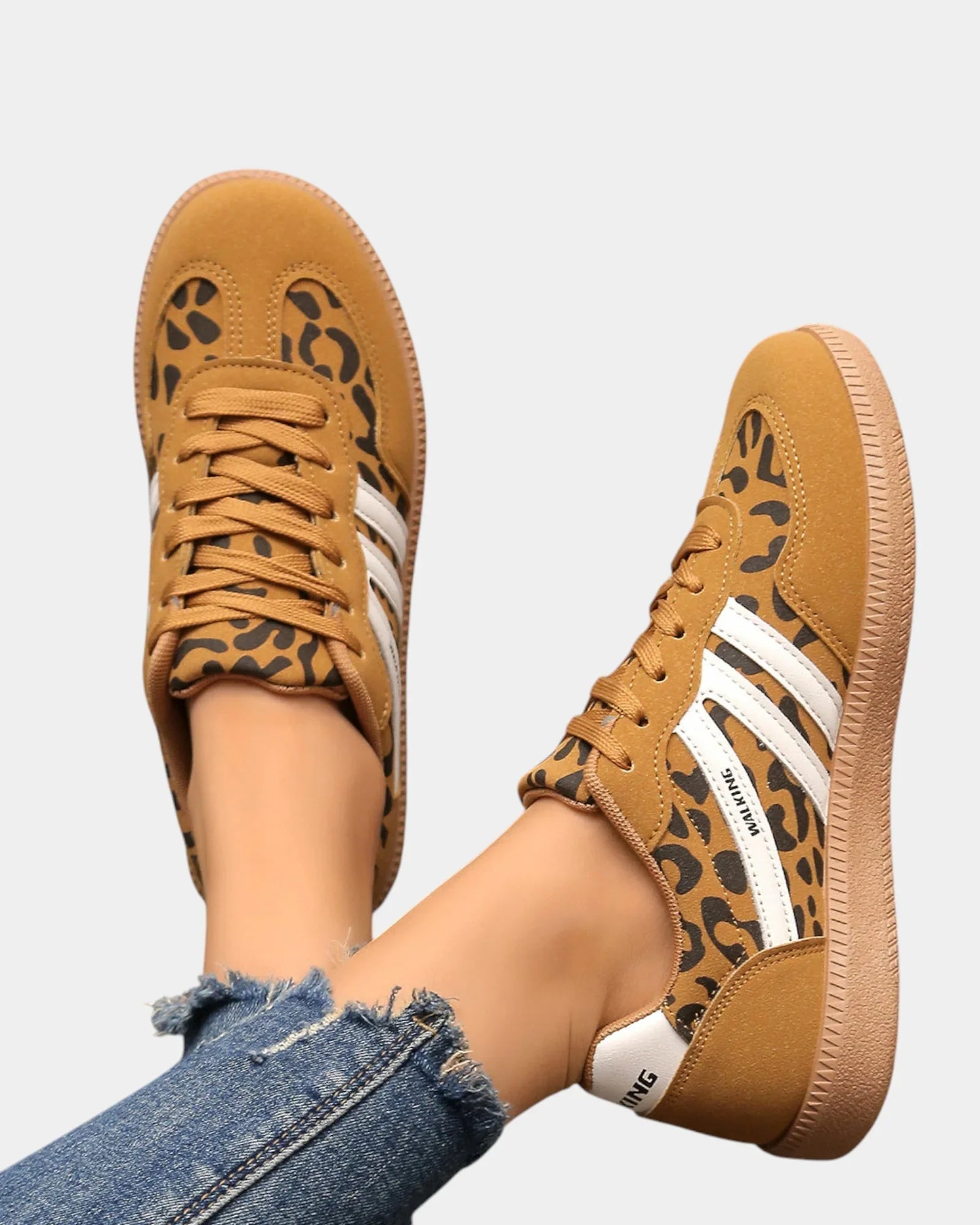 Leopard-print orthopedic sneakers with tan laces, white stripes, gum sole