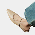 Beige pointed toe flats with ankle strap and small square buckle, low heel