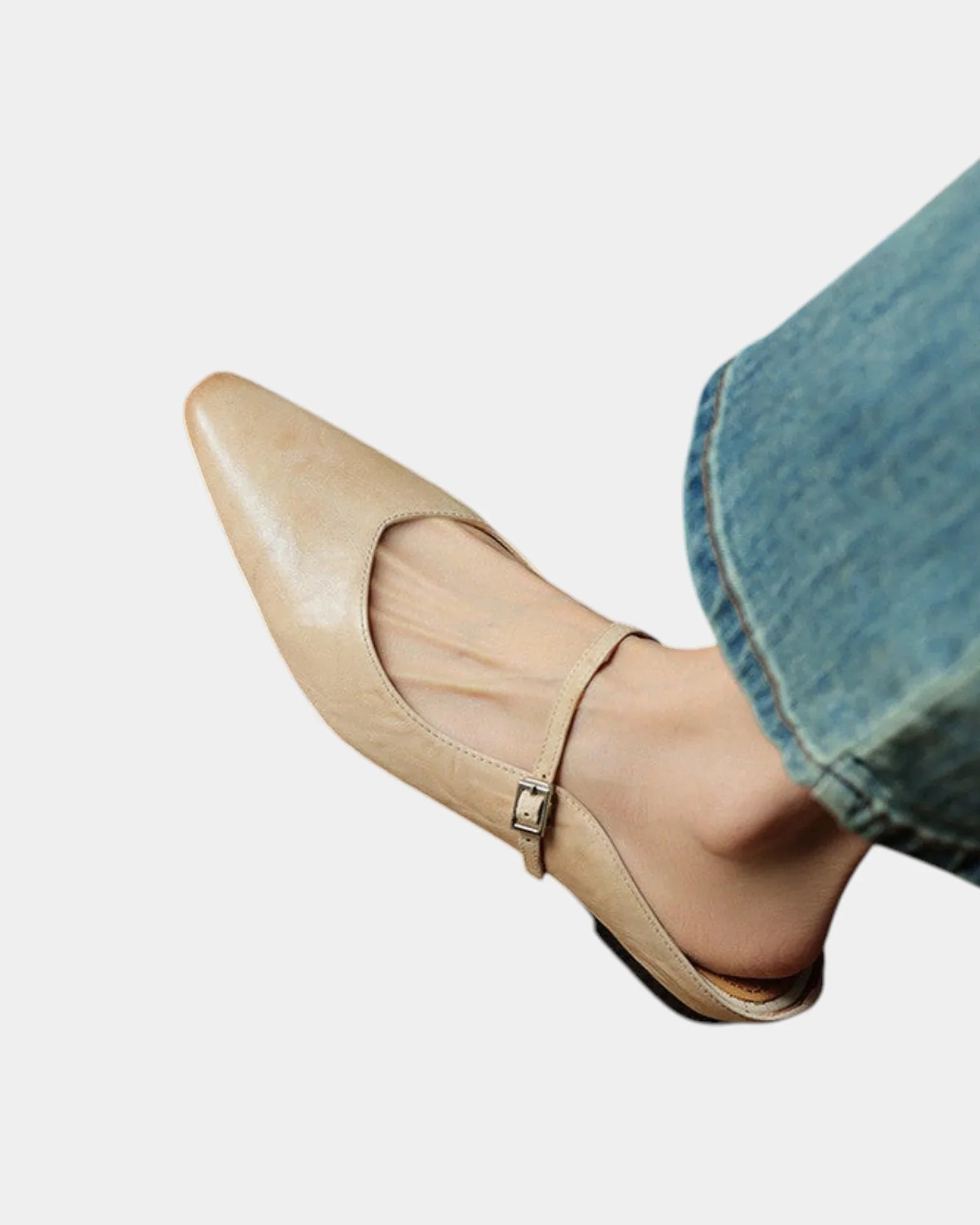 Beige pointed toe flats with ankle strap and small square buckle, low heel