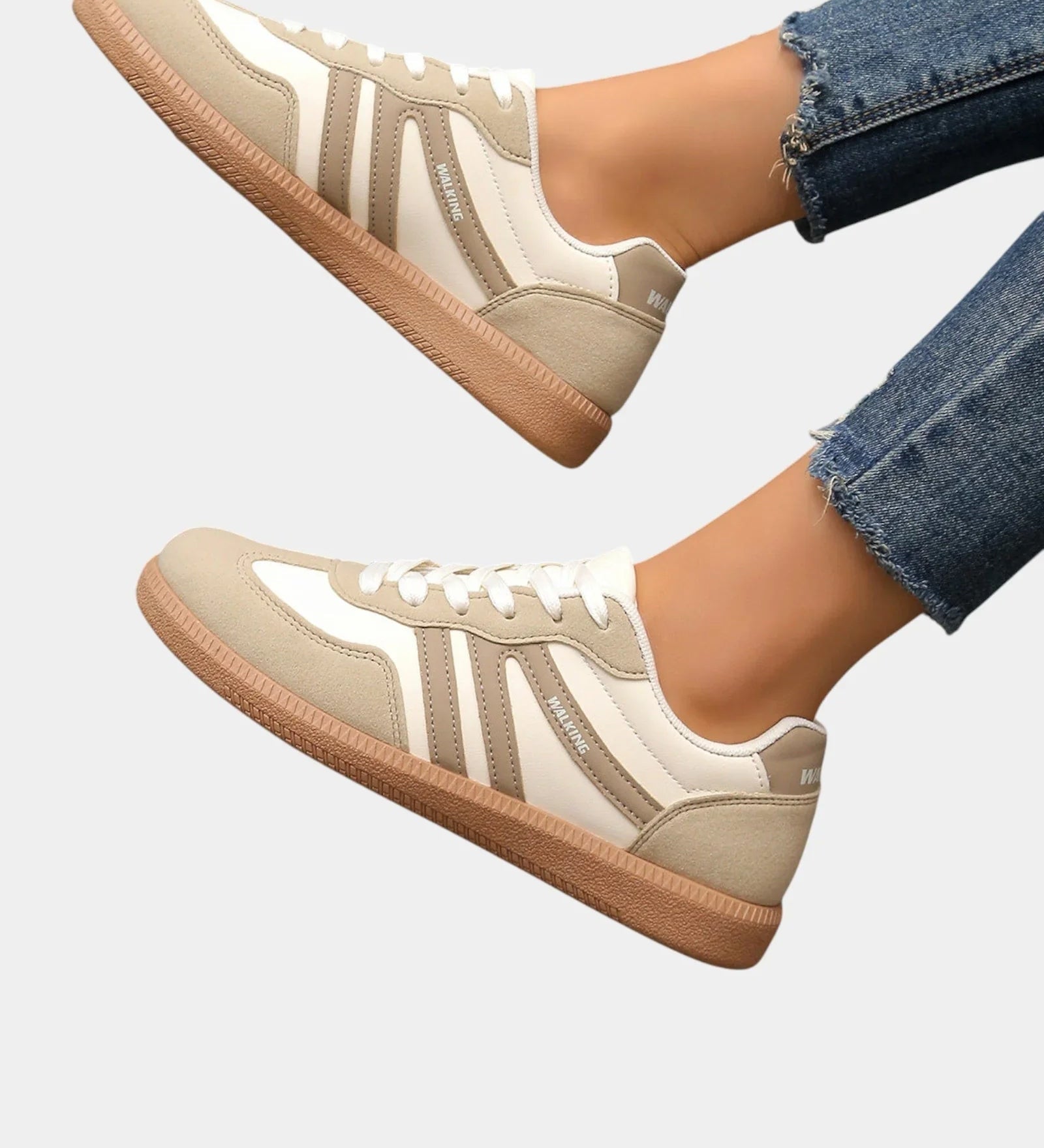Off-white orthopedic sneakers with tan gum sole and vertical side stripes