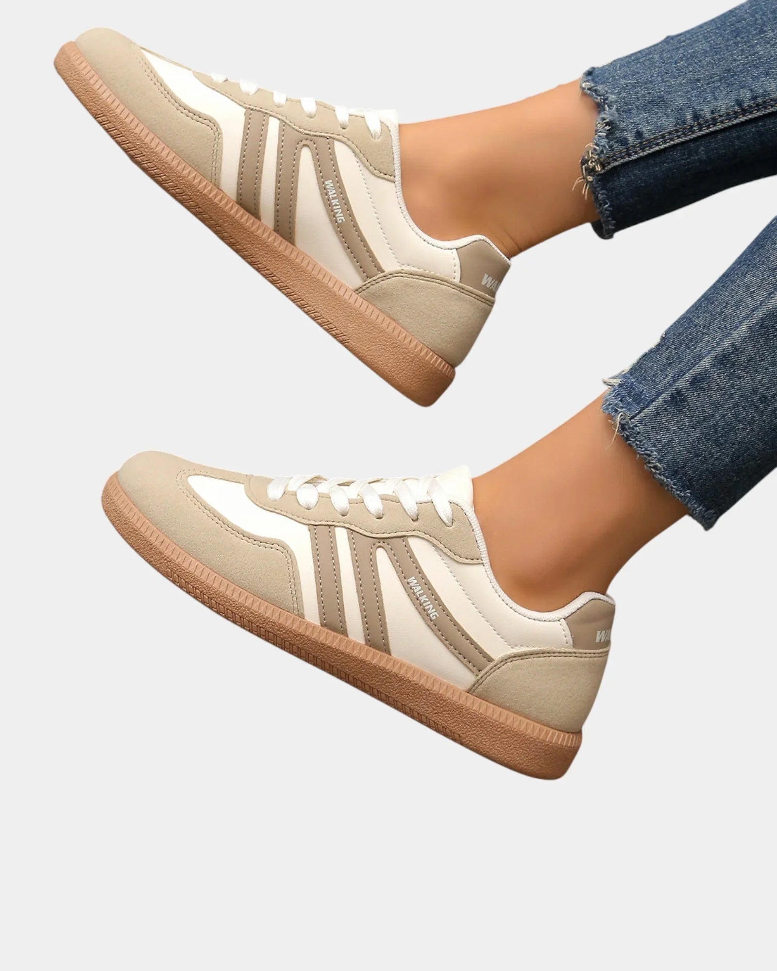 Off-white orthopedic sneakers with tan gum sole and vertical side stripes