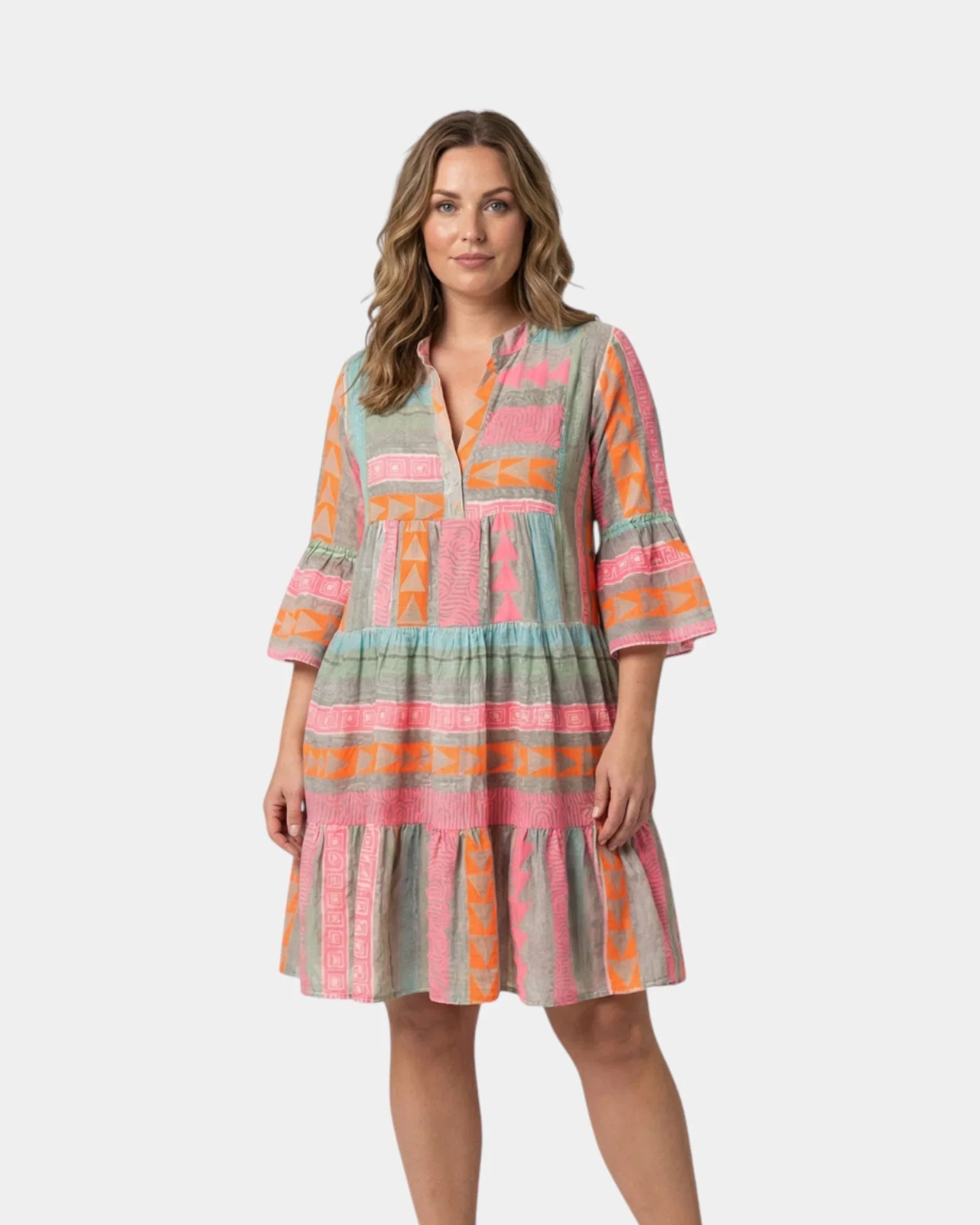 Printed midi dress with V-neck and tiered skirt, pink and orange geometric print on greenish fabric